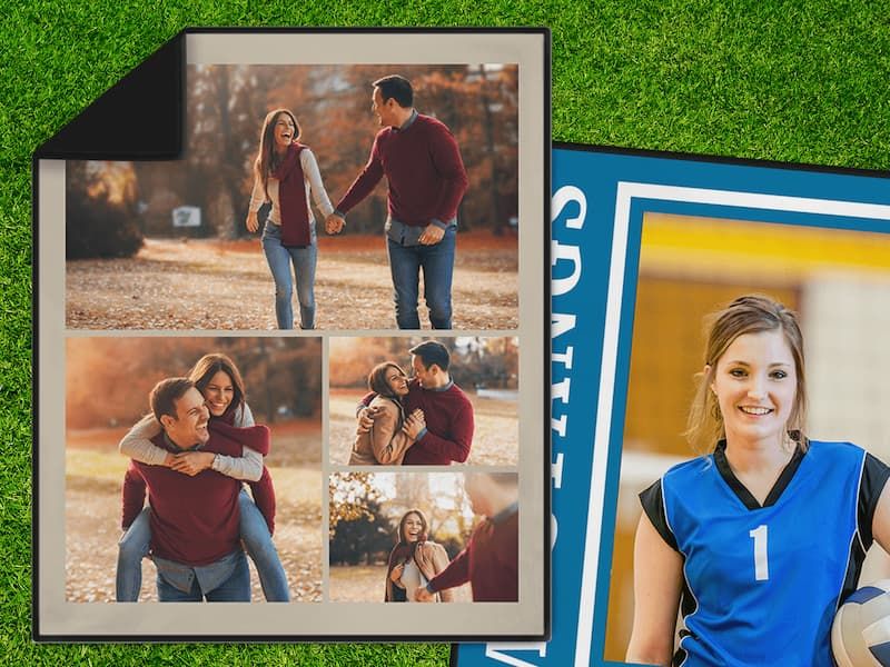 A tan-bordered fleece photo blanket with a collage of a couple in autumn leaves, laid on grass beside a blue sports-themed blanket featuring a volleyball player.